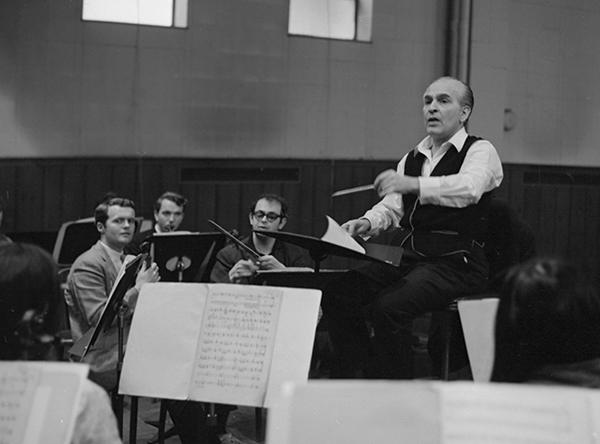 man conducting orchestra rehearsal